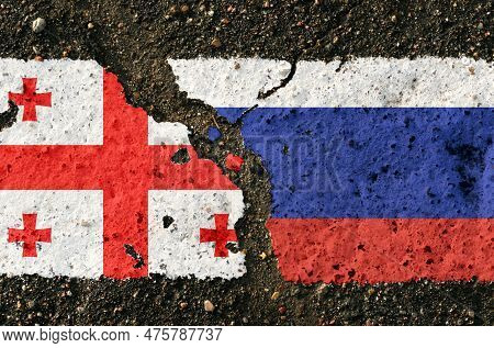 On The Pavement Are Images Of The Flags Of Georgia And Russia, As A Symbol Of Confrontation. Concept