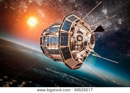 Space satellite orbiting the earth on a background star sun. Elements of this image furnished by NASA.