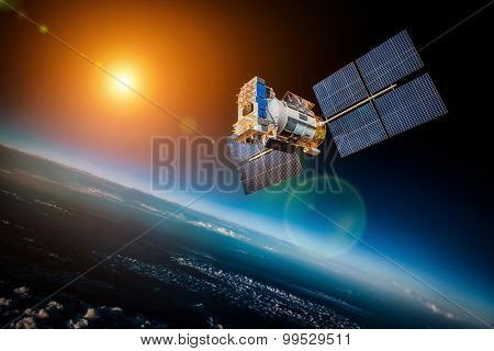 Space satellite orbiting the earth on a background star sun. Elements of this image furnished by NASA.