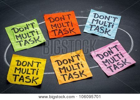 do not multitask sticky note abstract against blackboard - efficiency and productivity advice or reminder