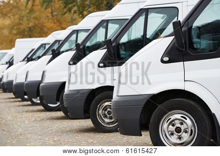 commercial delivery vans in row at parking place of transporting carrier shipping service company