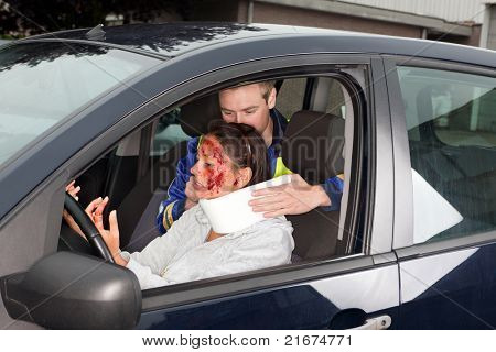 Injured woman in car crash getting a whiplash neck brace