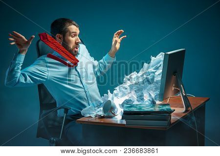 Young Stressed Handsome Businessman Working At Desk In Modern Office Shouting At Laptop Screen And B