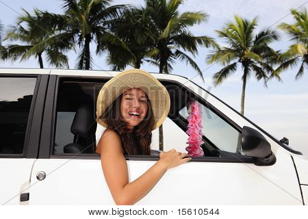 car rental: happy woman in her new car near the beach