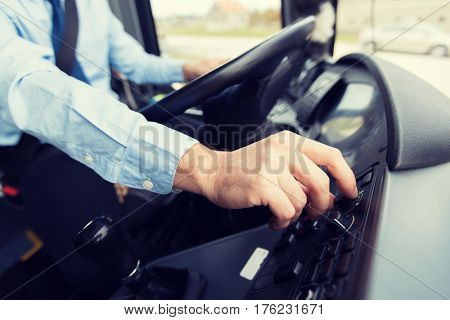 transport, transportation, tourism, road trip and people concept - close up of bus driver driving passenger bus