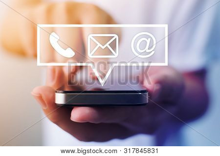 Close-up Image Of Male Hands Using Smartphone With Icon Telephone Email Mobile Phone And Address. Co