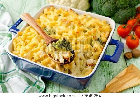 Casserole with pasta chicken broccoli and Bechamel sauce under a cheese crust