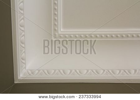 Ornamental White Molding Decor On Ceiling Of White Room Close-up Detail. Interior Renovation And Con