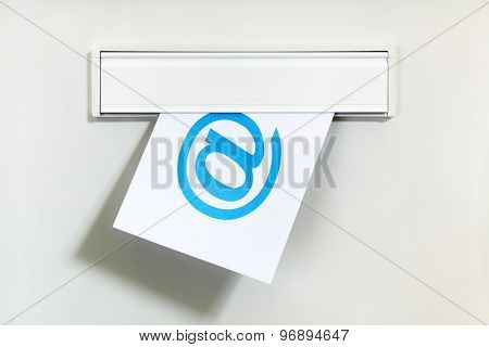 E-mail symbol on letter being delivered through a letterbox concept for internet communication, social media and contact us