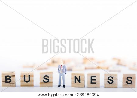 Business Leader Concept. Miniature People Small Figure Standing In The Middle Wooden Cube With Word 