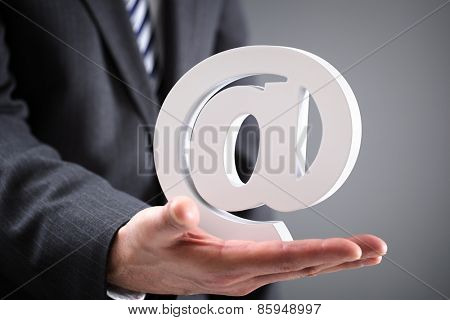 Businessman holding email at symbol concept for internet, contact and e-mail address