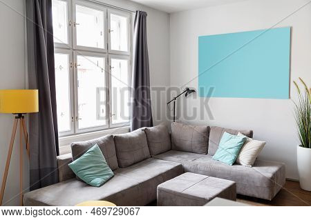 Cozy Living Room Interior With Comfortable Grey Sofa And Big Window