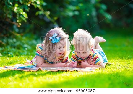 Two Kids Reading In Summer Garden