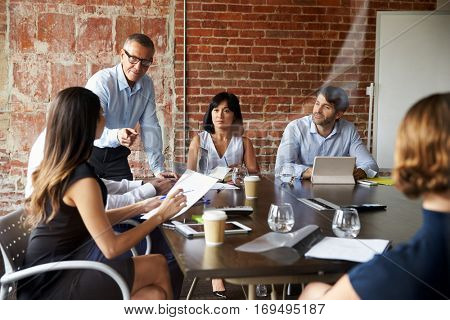 Businesspeople Meeting In Modern Boardroom Through Glass