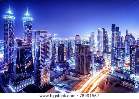 Dubai downtown night scene, UAE, beautiful modern buildings, bright glowing lights, luxurious travel and tourism 