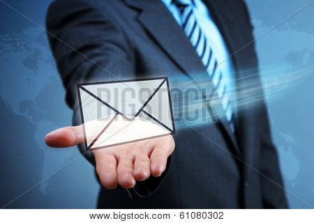 Businessman holding a virtual envelope concept for e-mail, global communications, mail or contact us