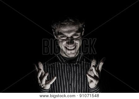 Man portrait with evil look isolated on black background.Face expression