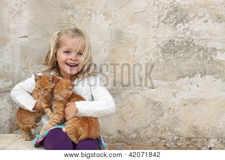 Cute Girl Holding Kittens