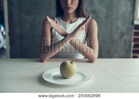 Woman Sitting On Chair With Crossed Hands. Diet Concept. Weight Loss Problem. Starving Young Woman. 