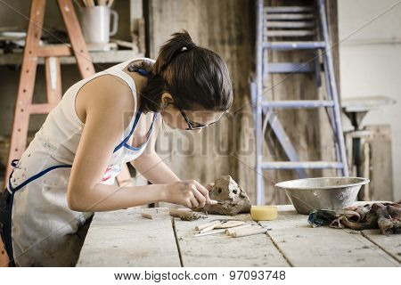 Young Artist Moulding Raw Clay In Art Studio