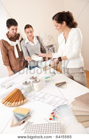 Female Interior Designer With Two Clients At Office