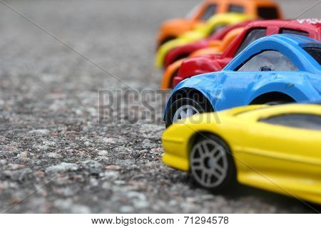 Miniature Colorful Cars Standing In Line On Road Sale Concept. Different Colored Cars - Blue, Yellow