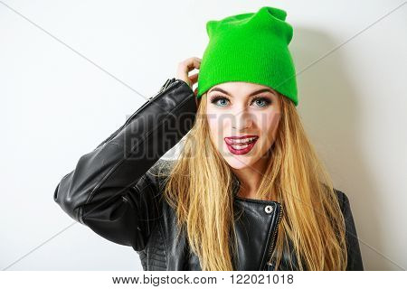 Portrait of Beautiful Street Style Hipster Girl in Beanie Hat Going Crazy on White Background. Not Isolated Photo with Shadow. Trendy Casual Fashion Outfit in Spring or Autumn. Copy Space.