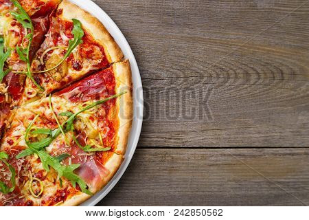 Italian Traditional Cuisine, Pizza, Food Background. Fresh Baked Pizza With Prosciutto And Arugula O