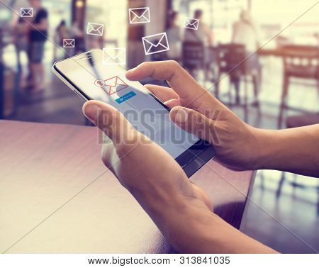 Hand Of Male Using Mobile Phone To Sending E-mail Message With Email Symbol And Envelope Icon. Email