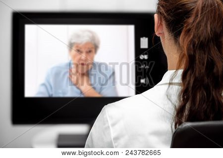 Elderly Woman With Dyspnea, Doctor Looking At The Desk, Telemedicine And Telehealth With Live Chat