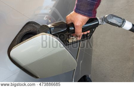 Refueling The Car At A Gas Station Fuel Pump. Man Driver Hand Refilling And Pumping Gasoline Oil The