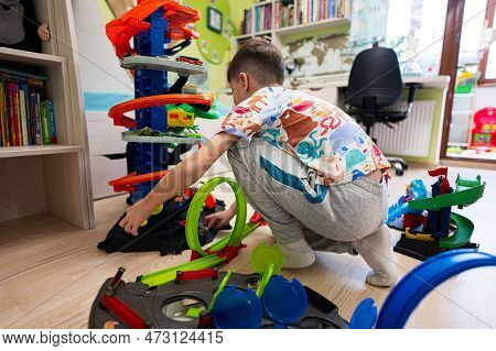 Kyiv, Ukraine - March, 2023: Boy Play With Collection Of Colorful Toy Cars. Hot Wheels Ultimate Gara