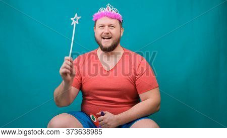 A Youna Young Bearded Freaky Man In A Pink T-shirt With A Diadem On His Head Riding A Unicorn With A