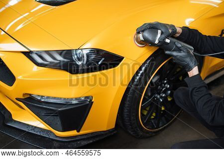 Auto Detailing Service, Polishing Of The Car. Close Up View Of Hands Of Man Worker, Polishing Hood A