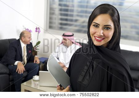 Arabian Businesswoman in office with Businesspeople meeting in the background, Arabian woman wearing