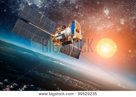 Space satellite orbiting the earth on a background star sun. Elements of this image furnished by NASA.