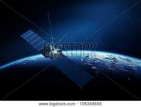 Communications satellite orbiting Earth with sunrise in space