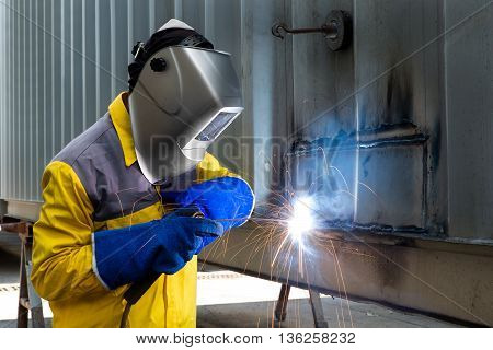 Industry Worker Welding concept - Industry worker with welding steel to repair container structures manufacture workshop.