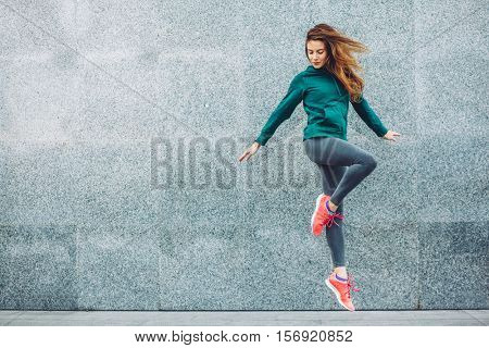 Fitness sport girl in fashion sportswear doing yoga fitness exercise in the street, outdoor sports, urban style