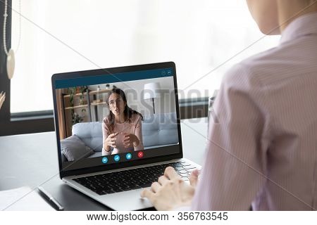 Businesswoman Having Distant Negotiations Using Video Conference Application On Pc