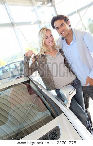 Happy couple holding new car keys