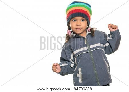 Mixed race little girl with a funny attitude wearing a colorful beanie hat and a jacket isolated on white