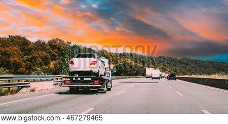 Tow Truck Transporting Car Or Help On Road Transports Wrecker Broken Car. Car Service Transportation