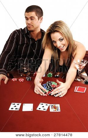 A sexy young blond winning the pot in a high stakes Texas Holdum Poker game Card backs are a digitally created design