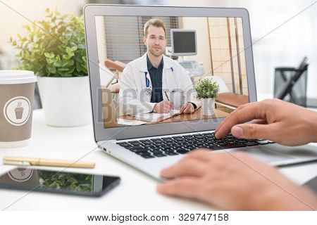 Doctor With A Stethoscope On The Computer Laptop Screen. Telemedicine Or Telehealth Concept.