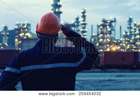 Engineer Is Standing On Large Industry Background.