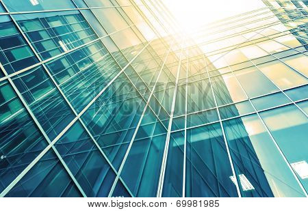 Panoramic and perspective wide angle view to steel light blue background of glass high rise building skyscraper commercial modern city of future. Business concept of successful industrial architecture